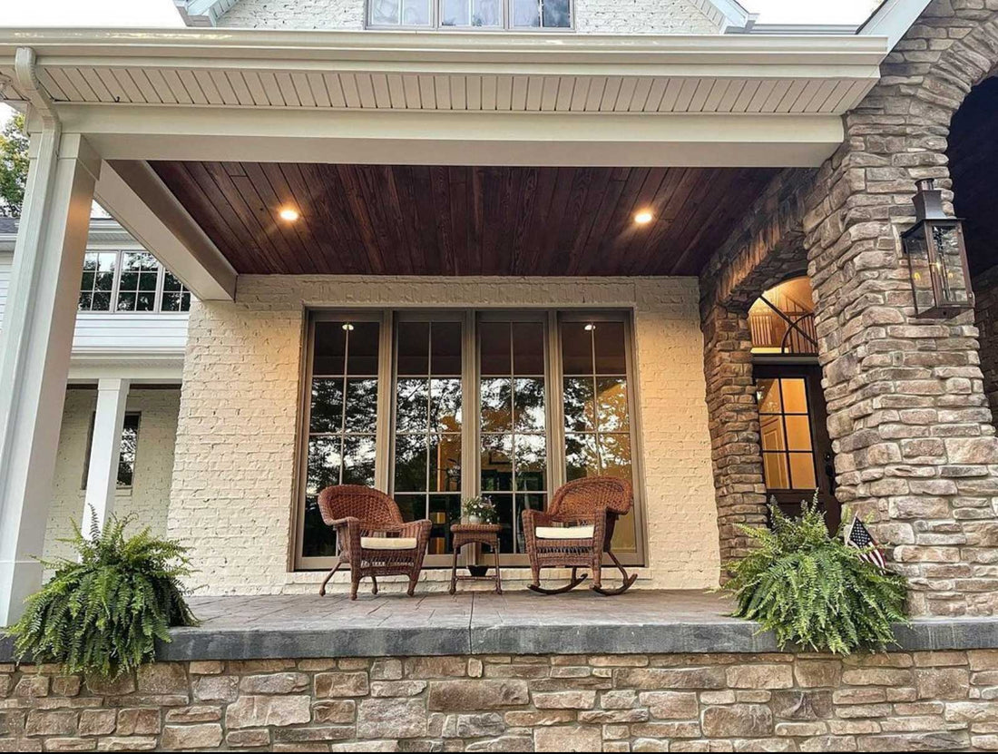 Ledgestone pillars and low wall around a covered porch with wood ceiling and seating, featuring Casa Di Sassi Matera Ledgestone.