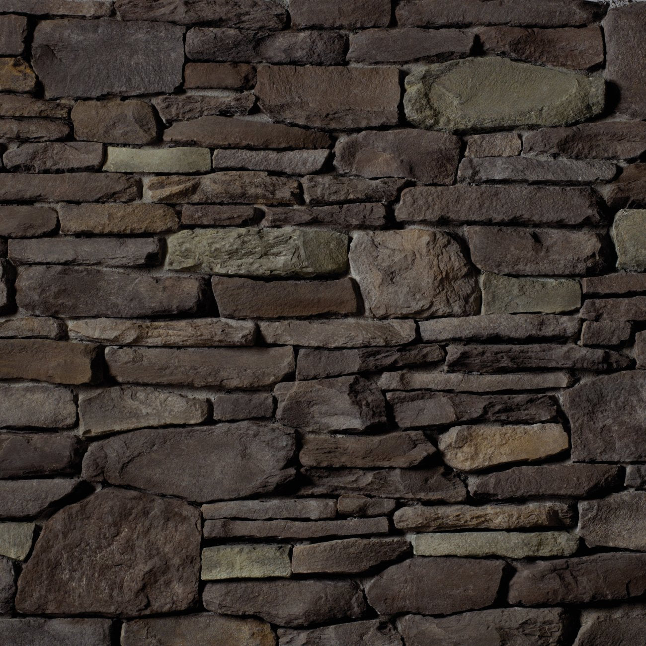 Cultured Stone Black Isle Del Mare Ledgestone veneer featuring deep charcoal-black tones, layered stacked texture, and rugged natural stone character