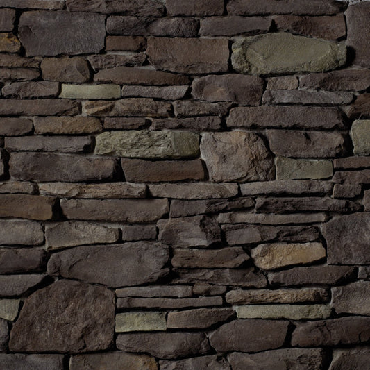 Cultured Stone Black Isle Del Mare Ledgestone veneer featuring deep charcoal-black tones, layered stacked texture, and rugged natural stone character