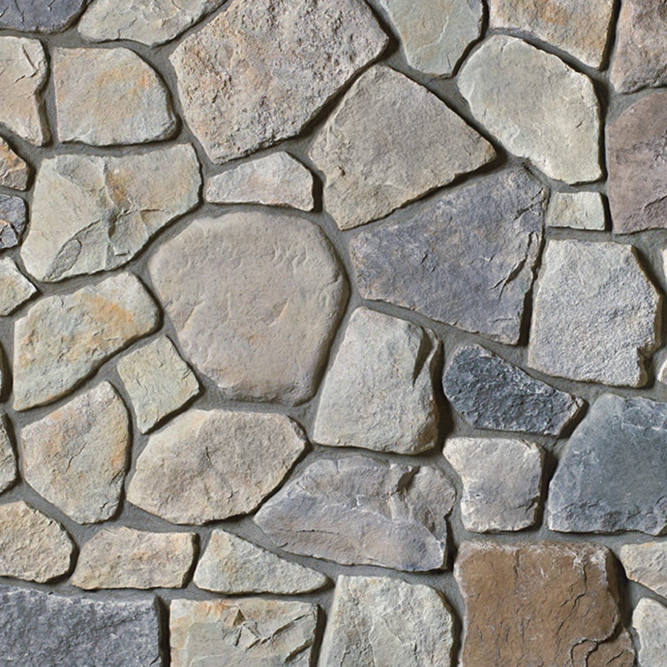 Cultured Stone Echo Ridge Dressed Fieldstone veneer featuring mixed earth-and-gray tones, chiseled dressed texture, and authentic natural stone character.