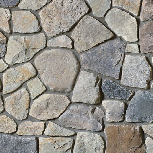 Cultured Stone Echo Ridge Dressed Fieldstone veneer featuring mixed earth-and-gray tones, chiseled dressed texture, and authentic natural stone character.