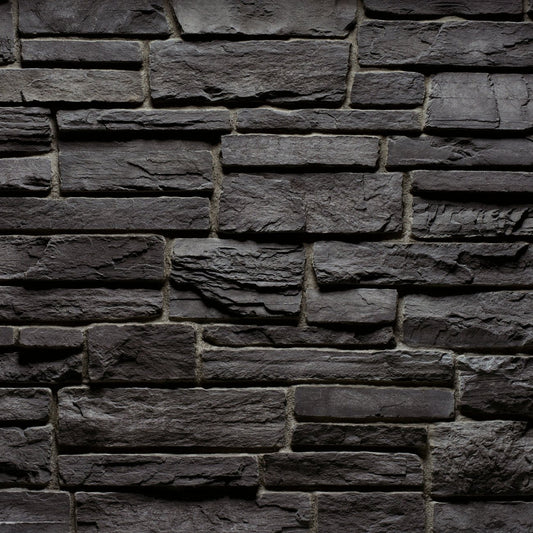 Cultured Stone Gunnison Country Ledgestone veneer featuring deep gray and charcoal tones, layered stacked texture, and bold rugged stone character.