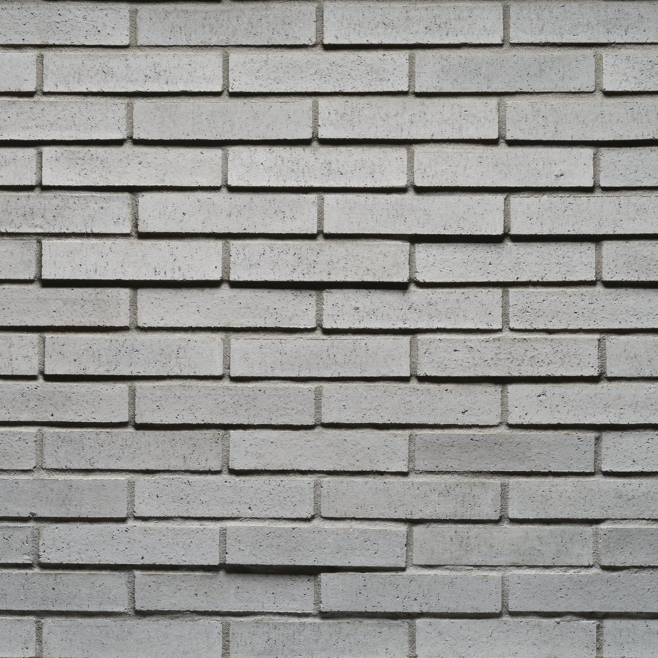 Cultured Stone Kullen Tenley Brick veneer featuring deep charcoal and dark gray tones, slim linear brick profile, and modern masonry texture