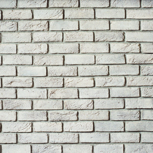 Cultured Stone Titanium handmade brick veneer featuring cool silver-gray tones, artisan texture, irregular edges, and rugged brick character.