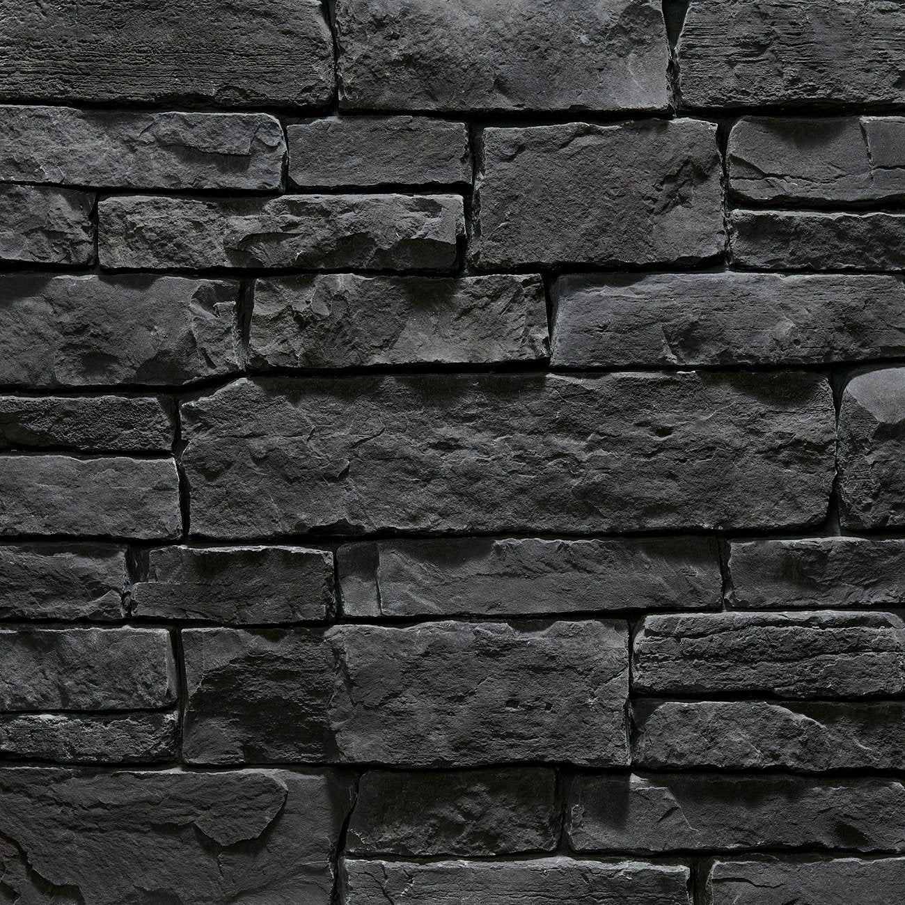 Dutch Quality Coal Crest Weather Ledge veneer featuring deep charcoal tones, weathered layered texture, and rugged dimensional ledgestone character.