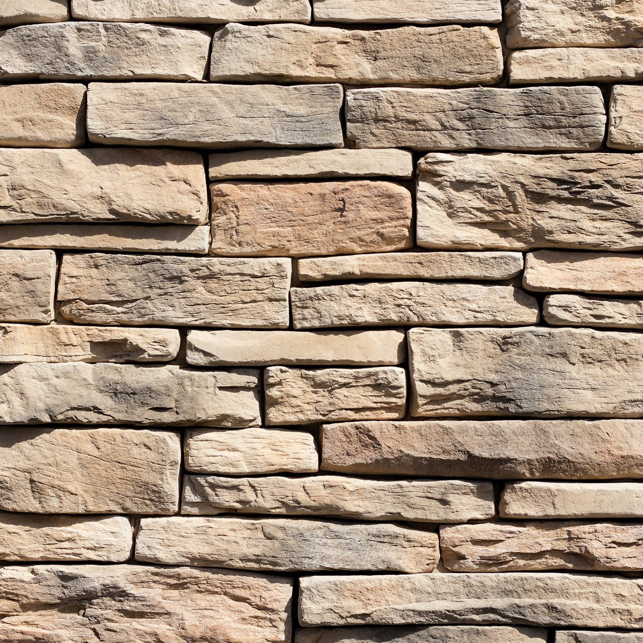 Dutch Quality Fallbrook Stack Ledge veneer featuring warm brown and gray tones, layered stacked texture, and dimensional ledgestone character.