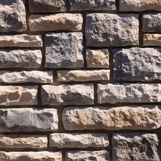 Dutch Quality Kentucky Blend Limestone veneer featuring warm brown and gray tones, chiseled limestone texture, and classic rectangular stone profiles