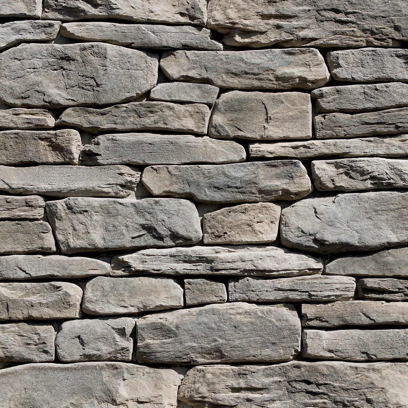 Dutch Quality Quail Grey Ledgestone veneer featuring soft gray tones, layered split-face texture, and refined modern stone detailing