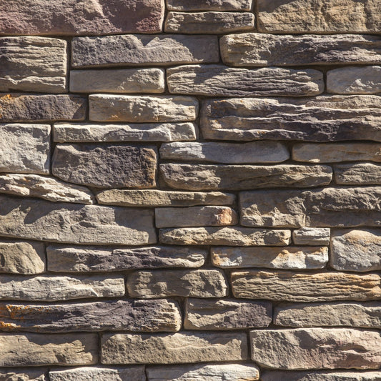 Dutch Quality Sagewood Ledgestone veneer featuring warm earth tones, layered split-face texture, and natural stacked-stone character