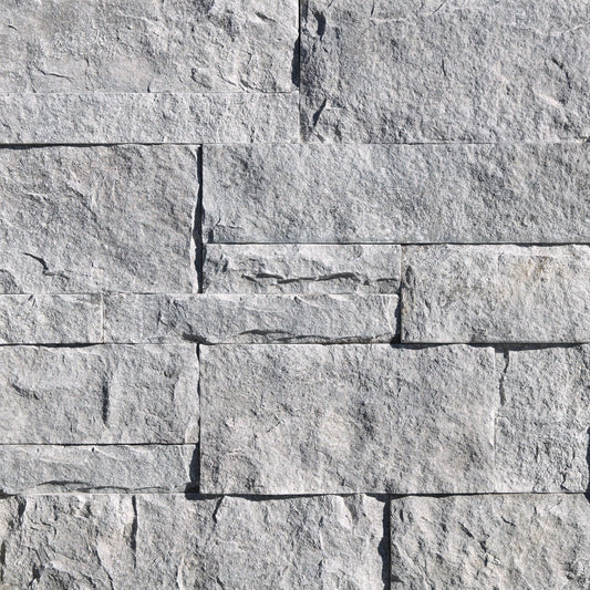 Eldorado Cannonade Cut Coarse Stone veneer in warm gray and charcoal hues with linear, split-face stone texture