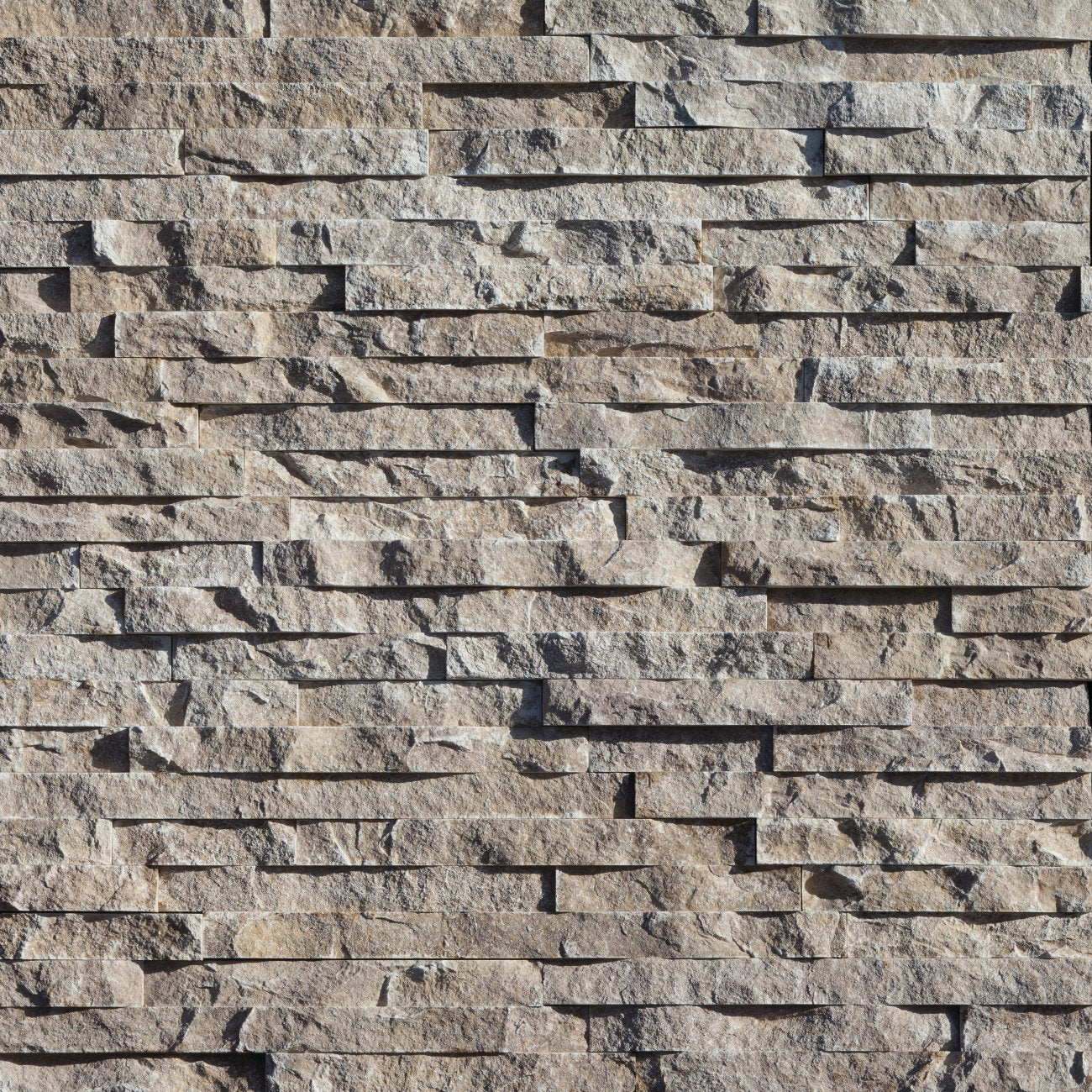 Eldorado Cottonwood European Ledge stone veneer in soft cream and beige hues with linear, chiseled stone texture