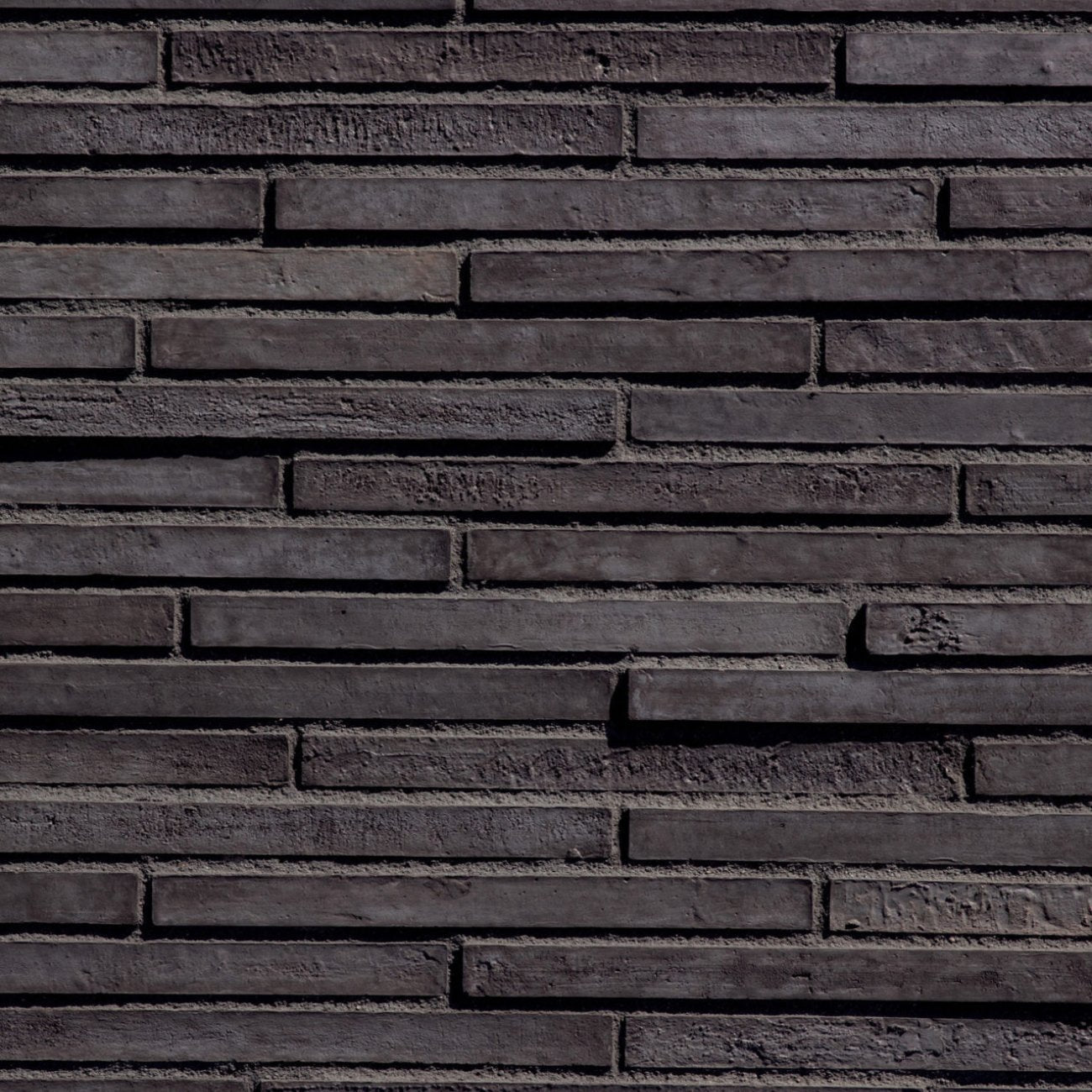 Eldorado Hollin LoreioBrick thin brick-style stone veneer in soft gray, taupe, and brown tones with subtle texture