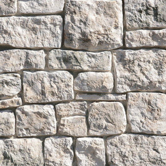 Eldorado Loire Valley RoughCut stone with rugged chiseled texture in warm cream, taupe, and beige tones