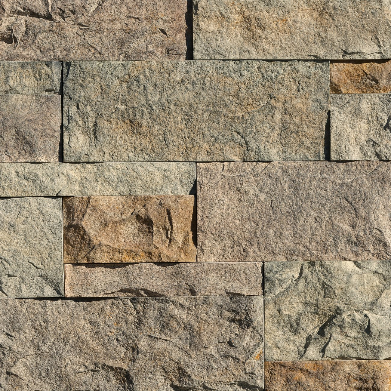 Eldorado Madrona Cut Coarse Stone veneer in warm brown and taupe hues with linear, hand-dressed stone texture