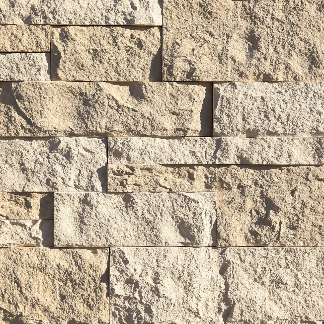 Eldorado Seashell Cut Coarse Stone veneer in cream and beige hues with linear, split-face stone texture