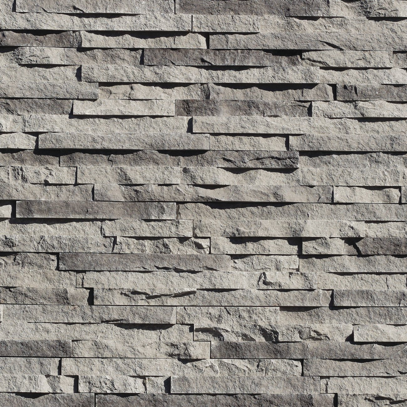 Eldorado Sidewalk European Ledge stone veneer in cool gray and charcoal hues with linear, chiseled stone texture