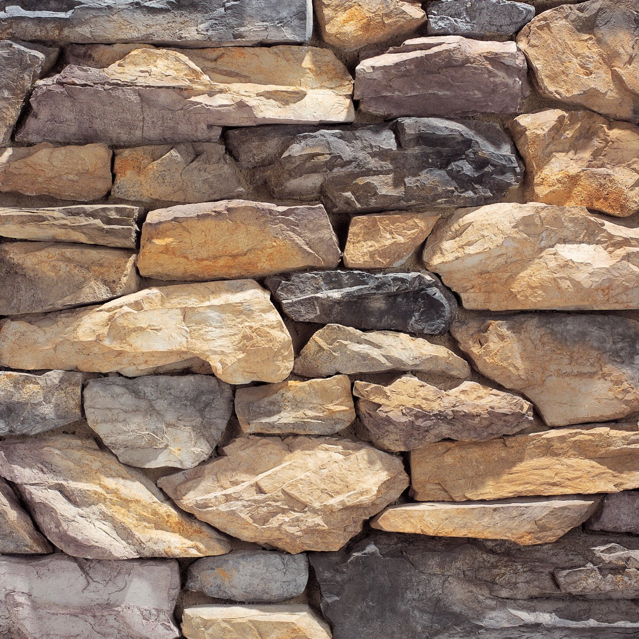 Eldorado Somerset Shadow Rock with rugged, irregular stone faces in soft gray, taupe, and earthy tones