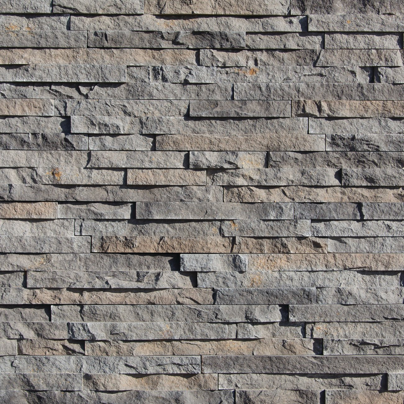 Eldorado Zinc European Ledge stone veneer in cool gray and charcoal hues with linear, chiseled stone texture