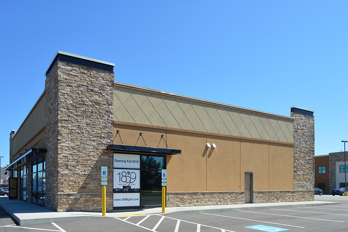 Commercial building with a sign indicating '1899' on a clear day.