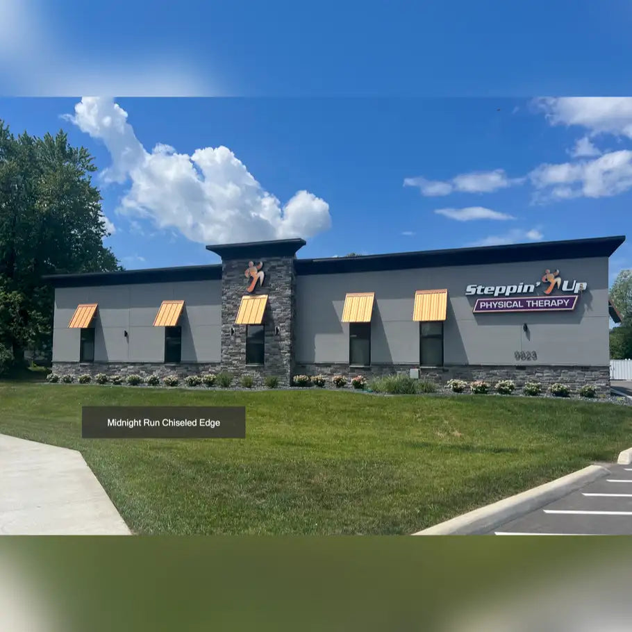 Midnight blue and gray building with stone accents, yellow awnings.