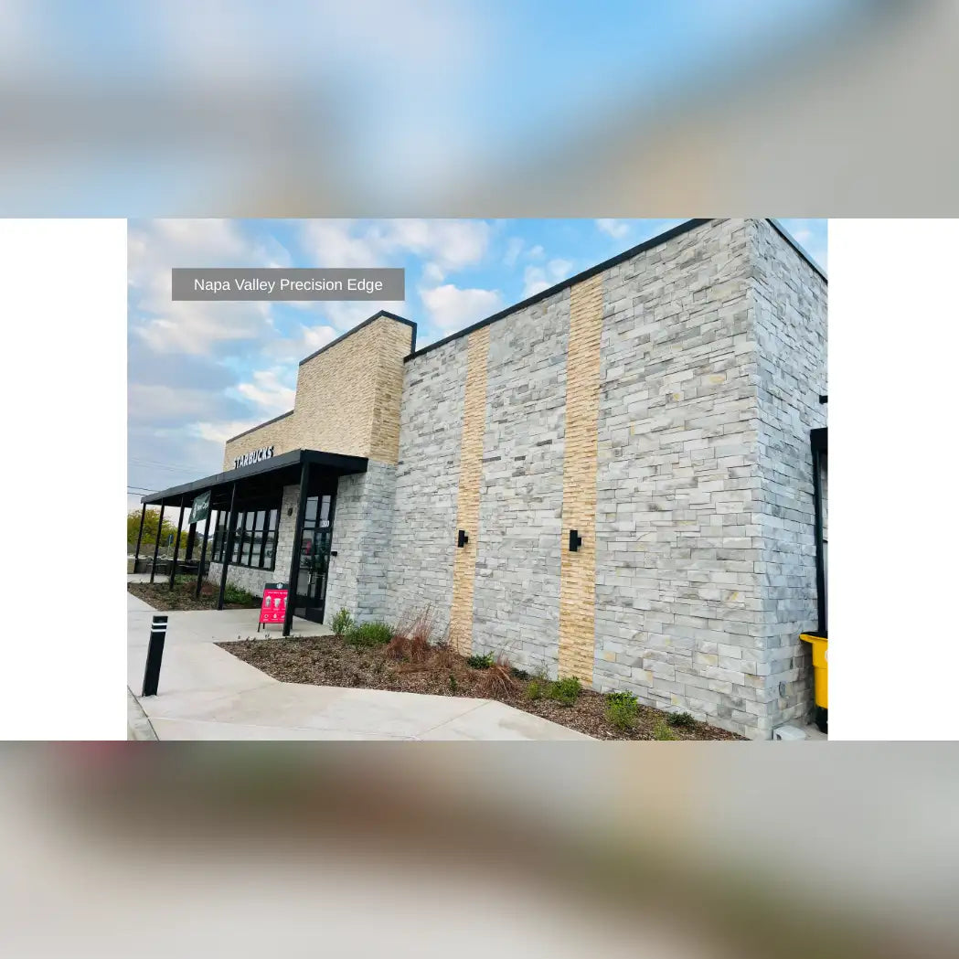 Modern stone facade building with gray and beige accents, black roof.