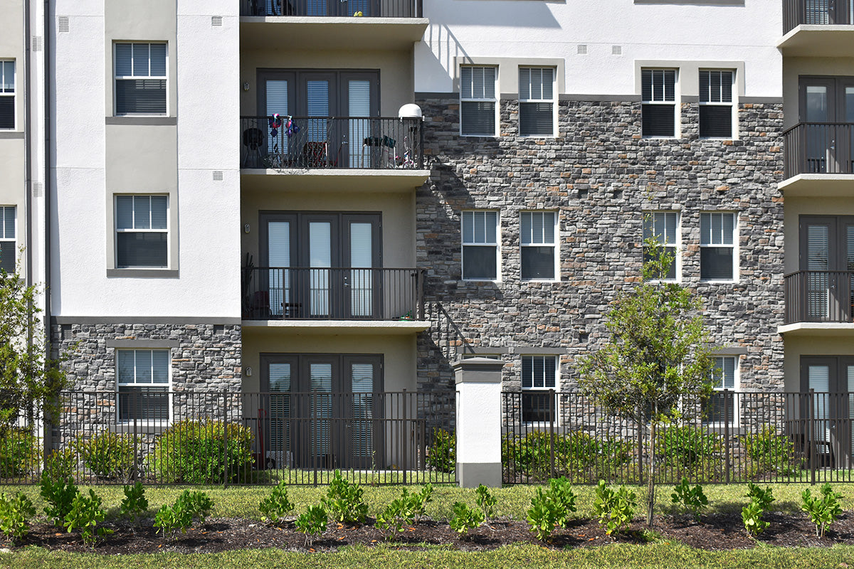 Multistory apartment building with stone facade and balconies