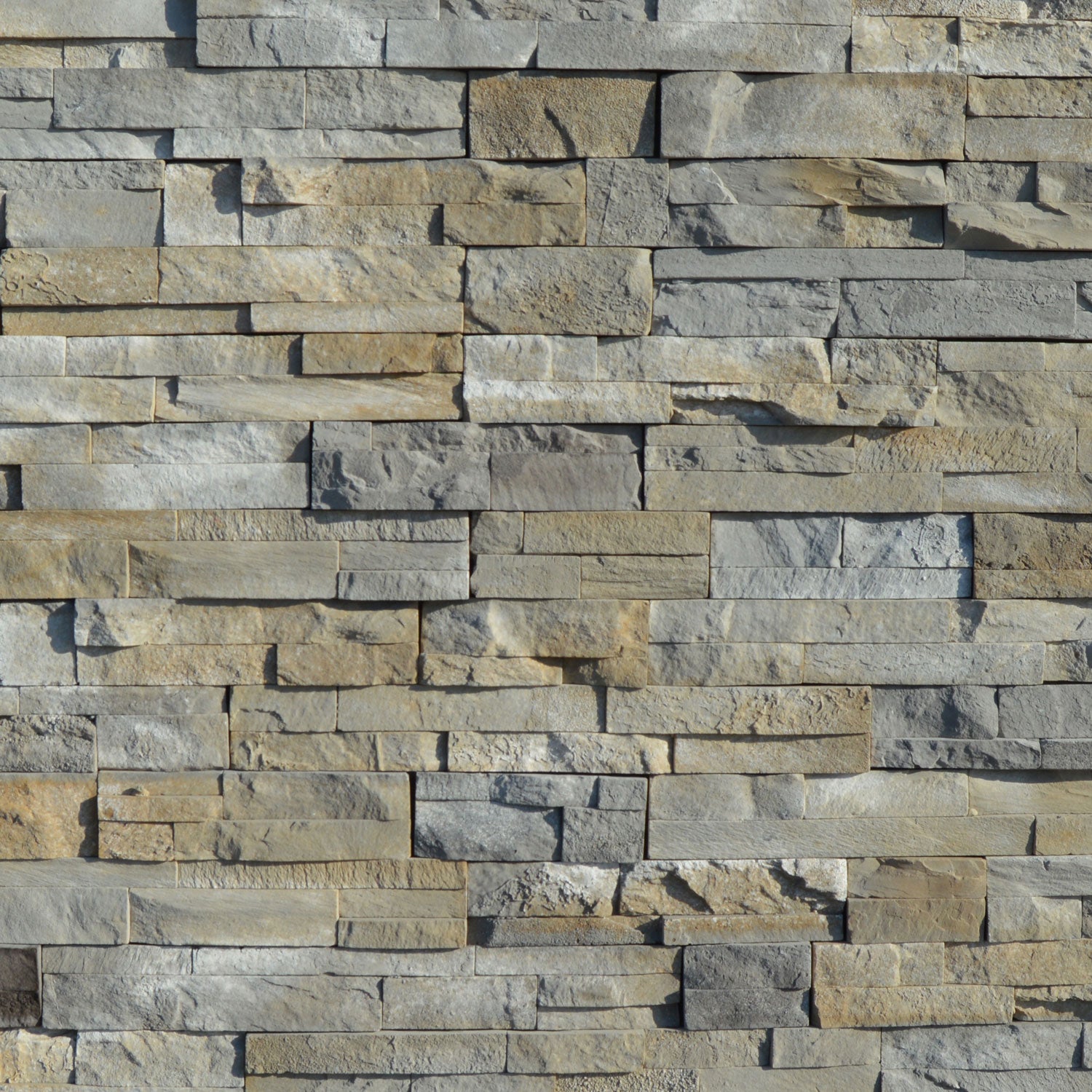 Pattern of stacked stone tiles in various shades of gray and brown.