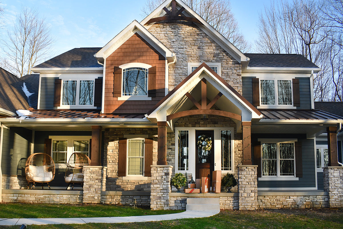 Stylish two-story house with a combination of brown, gray, and white exterior.