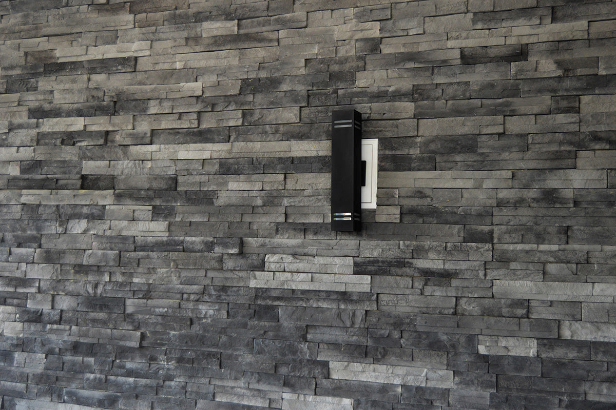 Dark stone wall with a small rectangular object on it