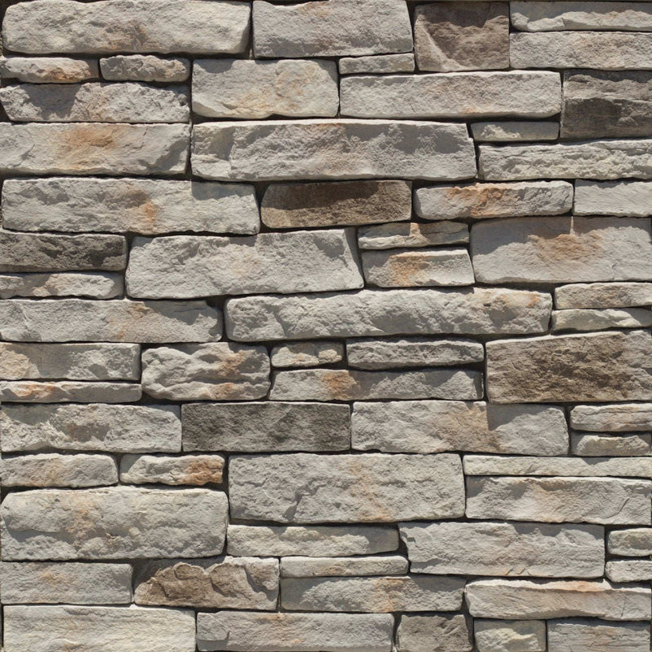 StoneCraft Hamilton Ledgestone stone veneer featuring gray and warm neutral tones, layered split-face texture, and dimensional stacked-stone character.