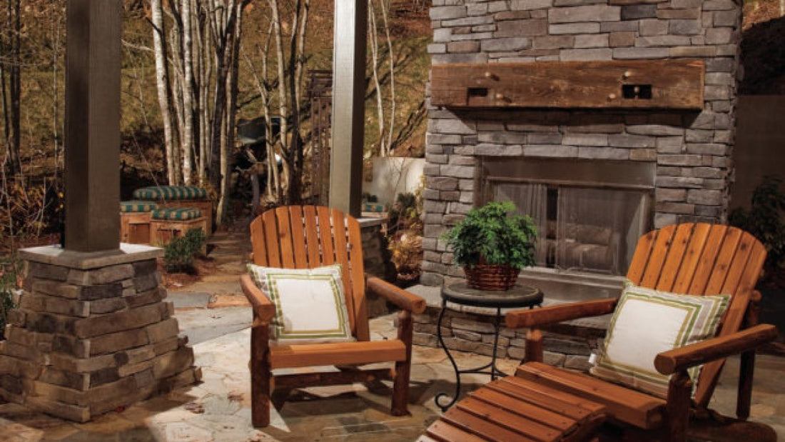 Ledgestone outdoor fireplace and columns beside wood chairs on a covered porch, featuring StoneCraft Pennsylvania Ledgestone.