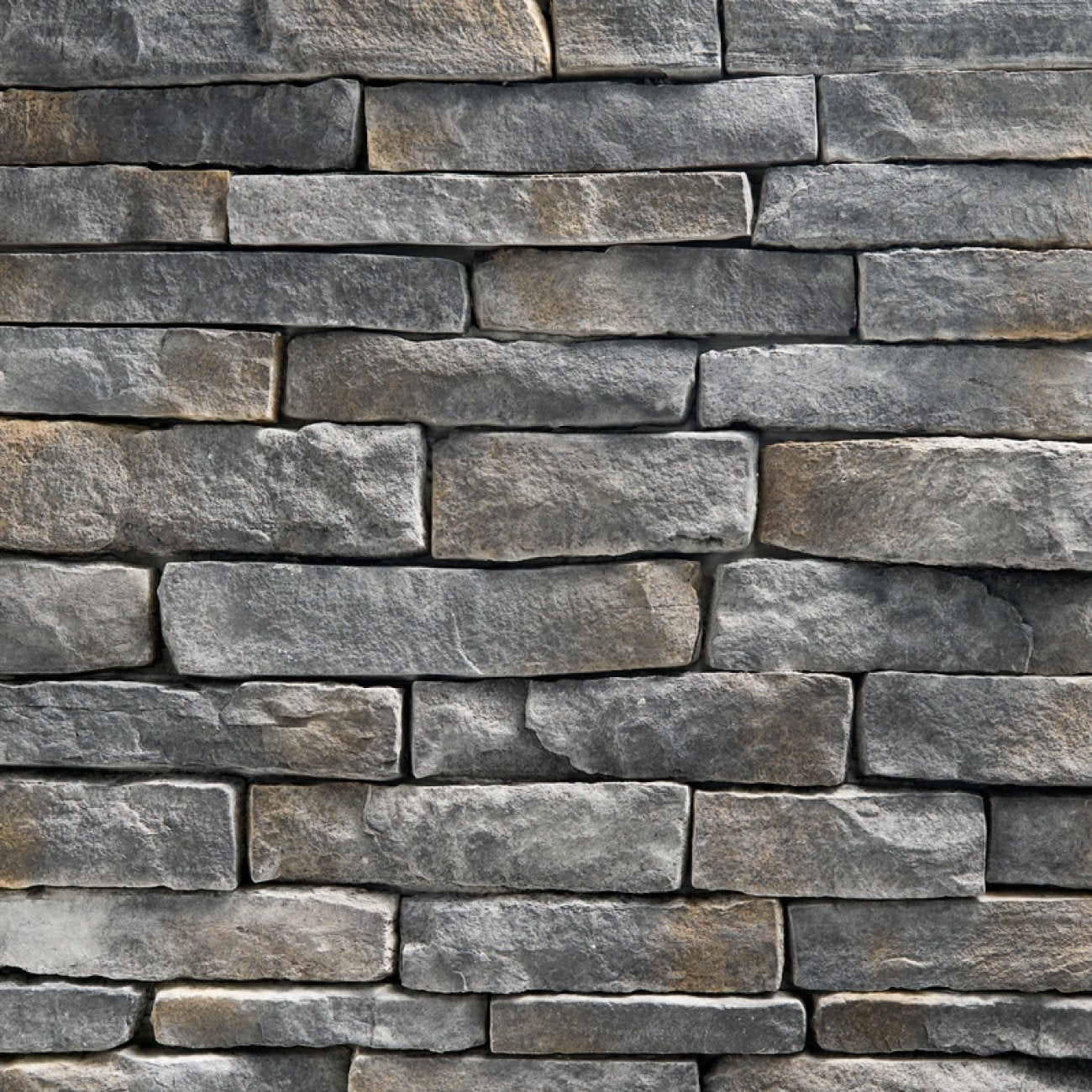 StoneCraft Steel Valley Ledgestone stone veneer featuring deep gray tones, layered split-face texture, and dimensional stacked-stone character