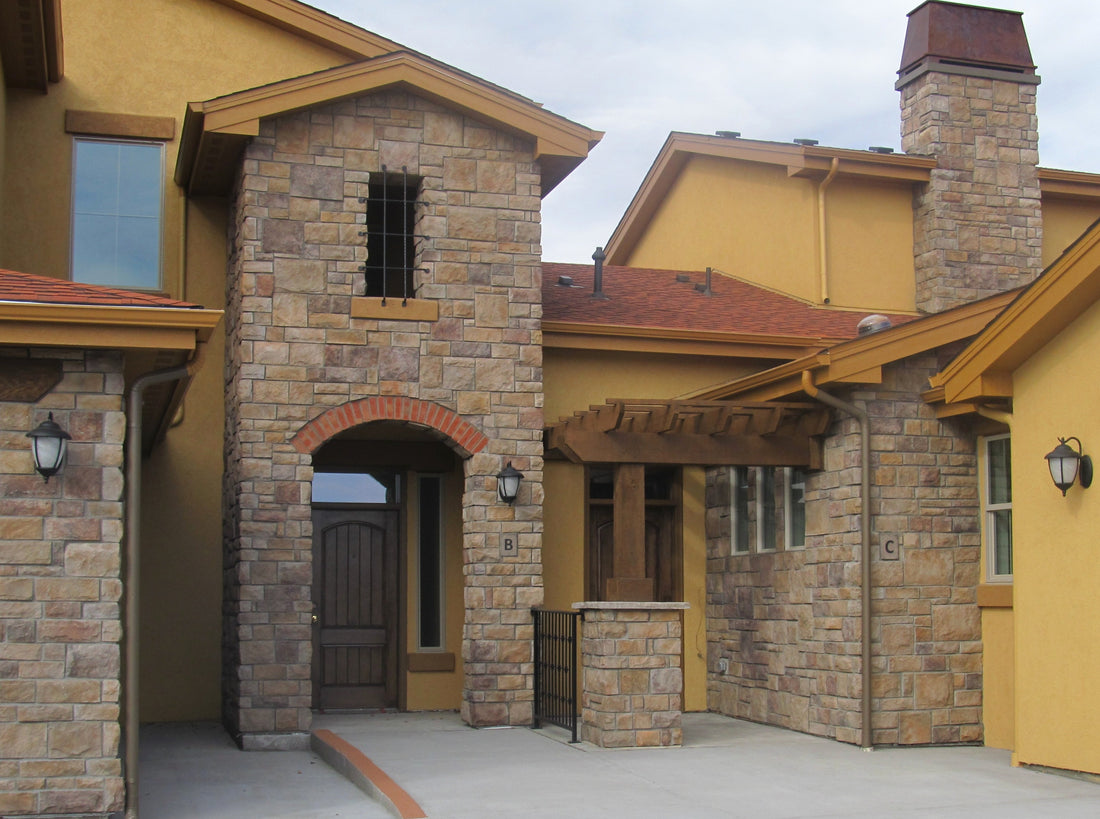 Warm limestone walls, arched entry tower and chimney around a courtyard, featuring Sunset Stone Georgetown Limestone.